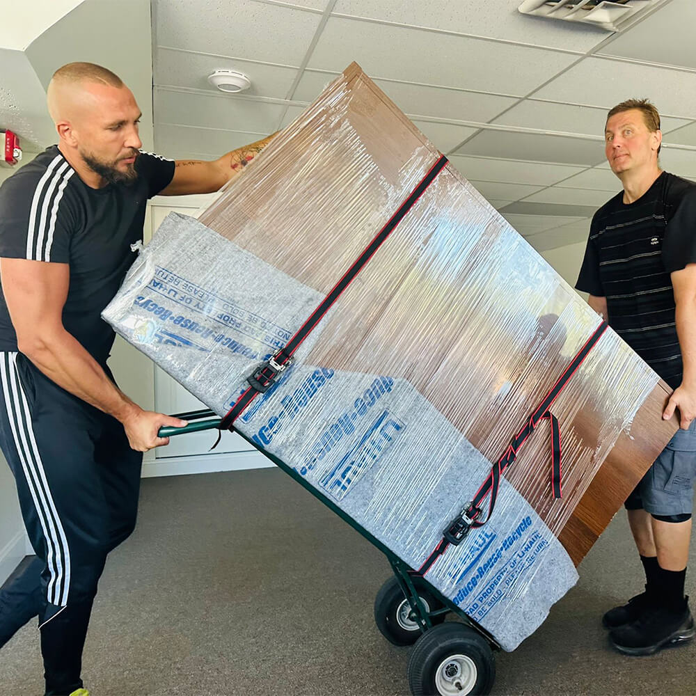 CarePhilly Movers Employees moving large furniture