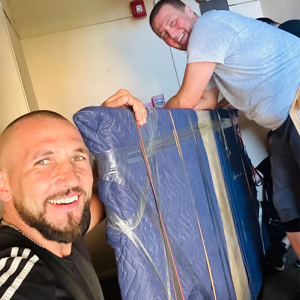 CarePhilly Movers Employees moving a pool table