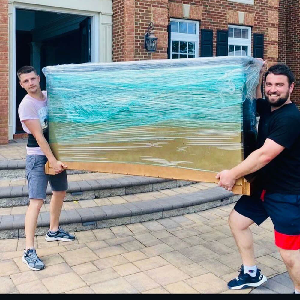 CarePhilly Movers Employees moving a fishtank